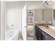 Bathroom featuring a soaking tub, granite countertops, dark wood cabinets and lots of lighting at 165 Birch St, Hiram, GA 30141