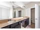 Bathroom with double vanity, granite countertops, dark wood cabinets and large mirror at 165 Birch St, Hiram, GA 30141
