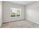 Neutral-toned bedroom features a large window for natural light at 165 Birch St, Hiram, GA 30141