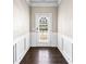 Inviting entryway with hardwood floors, white wainscoting, and a decorative front door, creating an elegant first impression at 165 Birch St, Hiram, GA 30141