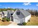 View of a well-maintained home with light gray siding, a dark roof, an attached garage, and a neatly landscaped lawn at 165 Birch St, Hiram, GA 30141