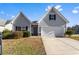 Charming single-Gathering home with a well-maintained front yard and attached two-car garage at 165 Birch St, Hiram, GA 30141