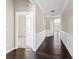 Hallway with hardwood floors, neutral walls, and white wainscoting, creating an elegant and inviting pathway at 165 Birch St, Hiram, GA 30141