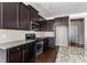 Well-appointed kitchen boasting stainless steel appliances and dark wood cabinetry at 165 Birch St, Hiram, GA 30141
