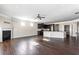 Open-concept living room features a fireplace, a ceiling fan, and view into kitchen at 165 Birch St, Hiram, GA 30141