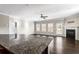 Bright living room with ceiling fan, fireplace, and kitchen island in foreground at 165 Birch St, Hiram, GA 30141