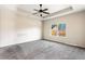 Spacious primary bedroom with tray ceiling, ceiling fan and view to outside at 165 Birch St, Hiram, GA 30141