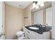 Traditional bathroom featuring a black granite vanity, white fixtures and neutral-toned walls at 2898 Lakemont Sw Dr, Marietta, GA 30060