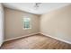 Bedroom features neutral walls, laminate wood flooring, and a large window with a wooded view at 2898 Lakemont Sw Dr, Marietta, GA 30060