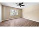 Bedroom with laminate flooring, neutral paint, ceiling fan, and large windows offering plenty of natural light at 2898 Lakemont Sw Dr, Marietta, GA 30060
