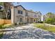 Inviting townhome featuring a well-maintained lawn, concrete driveway, and neutral color palette on a sunny day at 2898 Lakemont Sw Dr, Marietta, GA 30060