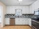 Modern kitchen with granite countertops, stainless steel appliances, white cabinets, and tile floors at 2898 Lakemont Sw Dr, Marietta, GA 30060