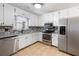 Modern kitchen with granite countertops, stainless steel appliances, and white cabinetry and decorative backsplash at 2898 Lakemont Sw Dr, Marietta, GA 30060