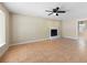 Bright living room featuring a fireplace, tile floors, ceiling fan, and an open layout to adjacent spaces at 2898 Lakemont Sw Dr, Marietta, GA 30060
