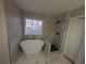Luxurious bathroom featuring a modern freestanding tub and separate tiled shower at 3442 Fox Hollow Dr, Marietta, GA 30068