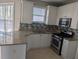 Bright kitchen featuring stainless steel appliances, granite countertops, and custom backsplash at 3442 Fox Hollow Dr, Marietta, GA 30068