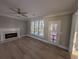 Bright room with a fireplace, ceiling fan, and ample natural light with backyard views at 3442 Fox Hollow Dr, Marietta, GA 30068