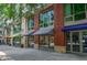 Street-level view of the building exterior with a mix of brick and stone facade at 905 Juniper Ne St # 110, Atlanta, GA 30309