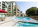 Exterior shot of a large community swimming pool and jacuzzi with lounge chairs at 905 Juniper Ne St # 110, Atlanta, GA 30309