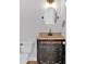 Classic bathroom with an oval mirror and decorative vanity at 9645 Dunhill Way, Cumming, GA 30028