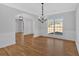Open dining room with hardwood floors, large windows, crown molding and decorative lighting for entertaining at 9645 Dunhill Way, Cumming, GA 30028