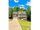 Attractive two-story home featuring a well-maintained lawn, a two-car garage, and a cozy front porch at 9645 Dunhill Way, Cumming, GA 30028