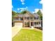 Charming two-story home with a brick and beige exterior, a two-car garage, and a welcoming front porch at 9645 Dunhill Way, Cumming, GA 30028