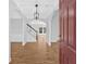 Elegant foyer with hardwood floors, arched doorways, pendant lighting and staircase to the second floor at 9645 Dunhill Way, Cumming, GA 30028