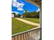 View from the porch of two homes, a long driveway, and lush green grass at 9645 Dunhill Way, Cumming, GA 30028
