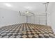 Spacious garage with checkered flooring and automatic door at 9645 Dunhill Way, Cumming, GA 30028