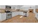 Well-equipped kitchen boasts stainless appliances, white cabinets, and granite countertops at 9645 Dunhill Way, Cumming, GA 30028