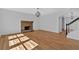 Spacious living room featuring a brick fireplace, hardwood floors, and natural light at 9645 Dunhill Way, Cumming, GA 30028