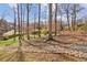 The backyard of this home features mature trees and landscaping and a dry creek at 2264 Winding Way, Tucker, GA 30084