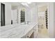 Bathroom with dual sinks set in a marble countertop and a large mirror at 2264 Winding Way, Tucker, GA 30084