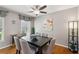 Neutral toned dining area with six chairs, hardwood floors, an elegant light fixture and a large decorative print at 2264 Winding Way, Tucker, GA 30084
