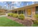 Charming home featuring a neatly manicured lawn, brick accents, and inviting yellow front door at 2264 Winding Way, Tucker, GA 30084