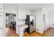Kitchen area featuring stainless steel refrigerator, granite countertops, and white cabinets, and hardwood floors at 2264 Winding Way, Tucker, GA 30084
