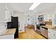 Spacious kitchen features white cabinets, granite countertops, stainless steel appliances, and hardwood floors at 2264 Winding Way, Tucker, GA 30084