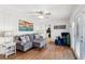 Bright living room featuring hardwood floors, a gray sofa and double doors leading to the back yard at 2264 Winding Way, Tucker, GA 30084