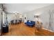 Cozy living and dining area featuring hardwood floors, a futon, a six-chair dining set, and neutral wall paint at 2264 Winding Way, Tucker, GA 30084