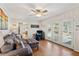 Comfortable living room featuring a gray sofa, hardwood floors and double doors leading to the back yard at 2264 Winding Way, Tucker, GA 30084