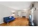 Bright living room with hardwood floors, a futon, decorative lamps, and a view of the adjacent dining area at 2264 Winding Way, Tucker, GA 30084