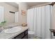 Cozy bathroom featuring a shower-tub combo with a white shower curtain and dark wood vanity at 262 Royal Crescent Ter, Canton, GA 30115