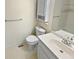 Clean bathroom featuring a toilet, vanity sink, and a well-lit mirror and overhead storage at 3705 Tradewinds Dr, Cumming, GA 30041