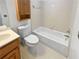 Simple bathroom featuring a white tub, toilet, and light wood vanity at 3705 Tradewinds Dr, Cumming, GA 30041