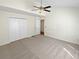 Bright bedroom with a ceiling fan, neutral carpet, and a spacious closet providing ample storage at 3705 Tradewinds Dr, Cumming, GA 30041