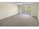 Comfortable bedroom with neutral carpet and sliding glass doors leading to an outdoor patio at 3705 Tradewinds Dr, Cumming, GA 30041