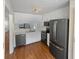 Bright kitchen with white cabinets, stainless steel appliances and hard wood floors at 3705 Tradewinds Dr, Cumming, GA 30041