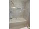 Elegant bathroom featuring a shower with stylish marble-look tile, rainfall shower head, and built-in niche at 4715 Greensprings Rd, College Park, GA 30337