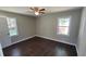 Spacious bedroom boasts hardwood floors, ceiling fan, and plenty of natural light from two windows at 4715 Greensprings Rd, College Park, GA 30337